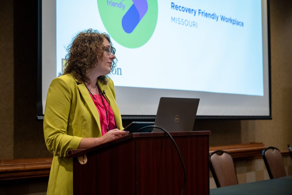 woman standing behind podium speaking